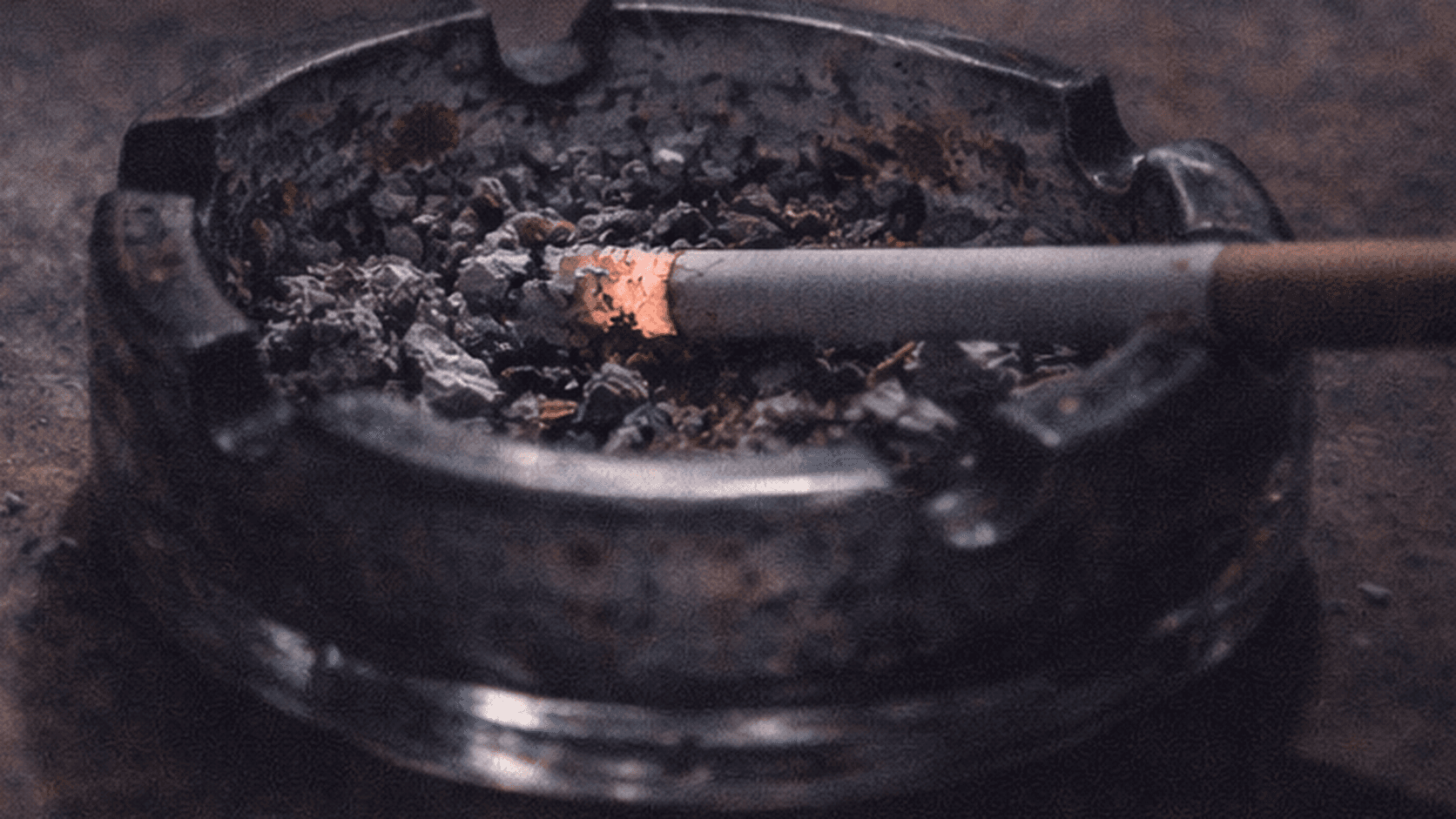 Cigarette in an ashtray representing relapse risk, cravings, and the need for support after setbacks