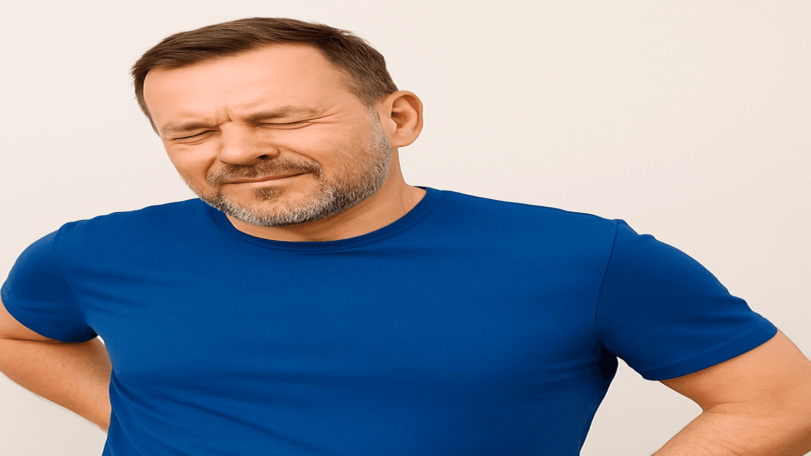 Man holding his lower back, representing chronic back pain and the search for support